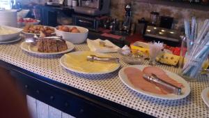 a buffet with plates of food on a table at Oihalia Guesthouse in Fidhákia