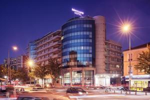 a building with a sign on top of it at night at Mercure Paris Saint-Ouen in Saint-Ouen