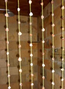 a string of lights hanging from a wall at Casa na Praia de Muriu - Andréia in Muriú