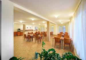 a restaurant with tables and chairs in a room at Penzion Krumlov - Massage studio in Český Krumlov