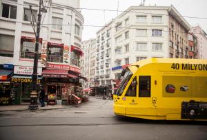 a yellow bus is driving down a city street at Istanbul Sirkeci Hotel in Istanbul