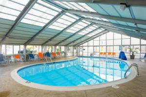 a large indoor pool with a glass ceiling at The Sea Ranch Resort in Kill Devil Hills