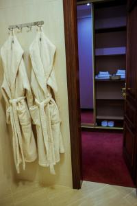 a bathroom with towels hanging on the wall at Warszawa Hotel in Lviv