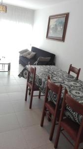 a room with two beds and a table at Apartamentos Loyo in Portomarin