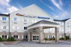 a large white hotel with a sign on the front of it at Baymont by Wyndham Lawrenceburg in Lawrenceburg
