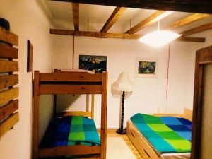 a bedroom with two bunk beds and a lamp at Nexus Kulcsoshaz Bukkloka Gyimes in Făgeţel