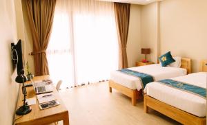 Postel nebo postele na pokoji v ubytování Minh Nhung Hotel