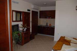 a kitchen with brown cabinets and a counter top at Apartments Krapina in Budva