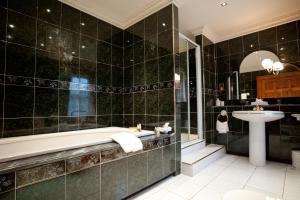 a bathroom with a tub and a sink at Culloden House Hotel in Inverness