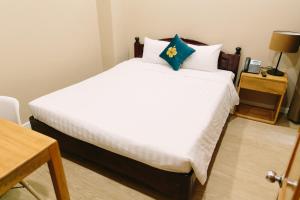 Postel nebo postele na pokoji v ubytování Minh Nhung Hotel