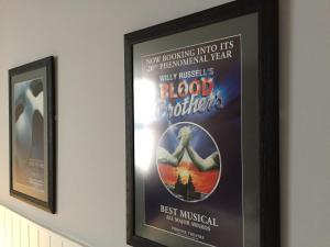a poster for a blood brothers movie hanging on a wall at Carlton Hotel in Ilfracombe
