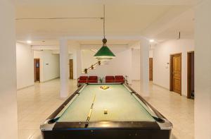 a pool table in the middle of a room at Hotel Sea Crown in Cox's Bazar