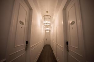 a hallway with a chandelier in the middle of a room at The Southern Boutique Hotel in George Town