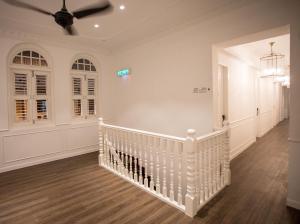 a white staircase in a home with a ceiling at The Southern Boutique Hotel in George Town