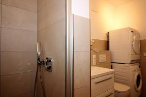 a small bathroom with a toilet and a sink at Wohnen am Yachthafen W25 in Cuxhaven +19 photos