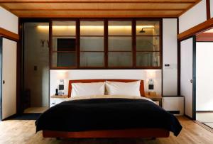 a bedroom with a large bed with a window at The Lodge MIWA in Kyoto