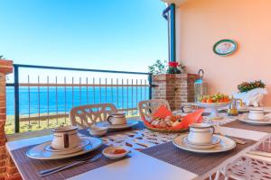 - une table avec de la nourriture et une vue sur l'océan dans l'établissement Casa Fiorita, à Sorrente