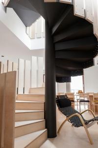 a spiral staircase in a building with a bench at Passivetxea in Íbero