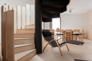a room with stairs and a chair and a table at Passivetxea in Íbero