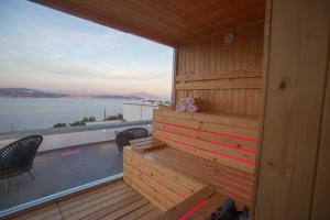 a wooden sauna with a view of the water at Hotel Cala Moresca in Bacoli