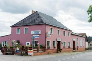 a pink building on the side of a street at Gasthaus&Pension Görsdorf in Lindenberg