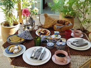 una mesa con platos de comida y tazas de café en Dar Eva, en Fez