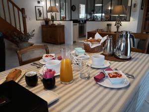 a table with food and a jug of orange juice at La Sembelie in Carsac-Aillac