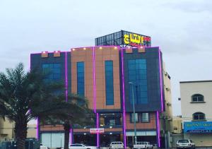 a building with a sign on the top of it at Almasah Altaj Aparthotel in Hail