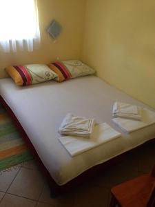 a bed with two towels on top of it at Novalja Zrce Apartment in Novalja +37 photos