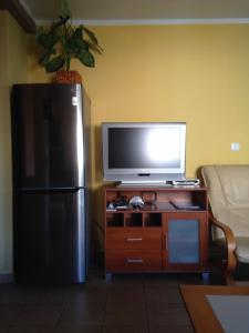 a living room with a television and a refrigerator at Novalja Zrce Apartment in Novalja