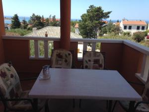 a white table and chairs on a balcony at Novalja Zrce Apartment in Novalja