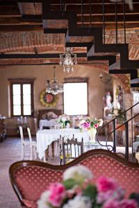 a dining room with a table with flowers on it at B&B Tenuta il Galletto in Casale Monferrato
