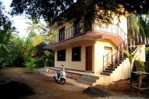 a scooter parked in front of a house at Sai Sneh Holidays Cottage in Alibaug