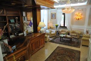 a living room with a couch and a table at Hotel Savona in Montecatini Terme