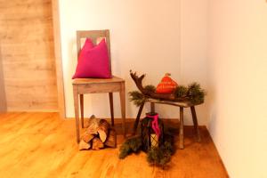 a pink pillow sitting on top of a chair in a room at Ferienhof Kreilgut in Rossleithen