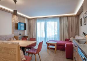 a living room with a couch and a table at Apartment Alpenland in Obergurgl