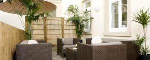 a lobby with couches and palm trees in a building at GuestHouse Heidelberg in Heidelberg