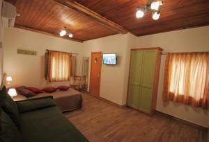 a bedroom with a bed and a couch in a room at Club Hotel Lo Sciatore in San Massimo