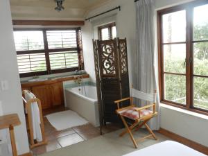 a bathroom with a bath tub and a sink at Sunset at Diluta in Cape Town +12 photos