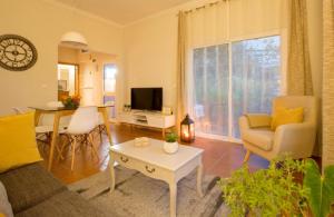 a living room with a couch and a table at Quinta do Bom Sucesso in Funchal