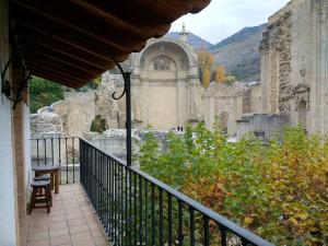 a balcony with a view of a building at Apartamentos Asador De La Plaza Vieja in Cazorla