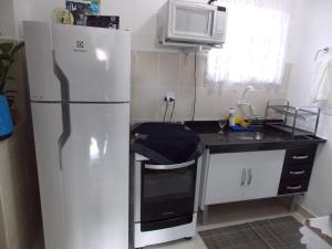 a kitchen with a refrigerator and a sink at Pedra Do Imperador in Nova Friburgo