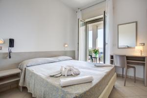 Posteľ alebo postele v izbe v ubytovaní Hotel Amedea
