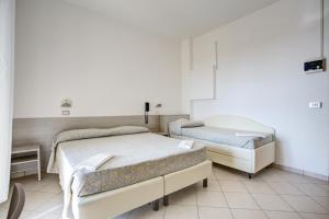 Posteľ alebo postele v izbe v ubytovaní Hotel Amedea