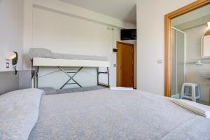 Posteľ alebo postele v izbe v ubytovaní Hotel Amedea