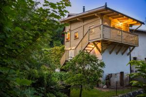 a tree house with a balcony on the side of a house at House Gabrijel with four seasons outdoor kitchen in Bled