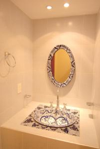 a bathroom with a plate on a counter with a mirror at Olga Querida B&B Hostal in Guadalajara