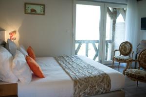 a bedroom with a large bed and a balcony at B&B Le Clos du Phare - En campagne in Saint-Samson-de-la-Roque +54 photos