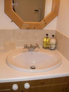 a sink in a bathroom with a mirror at Montacute Country Tearoooms in Montacute