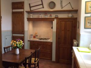 una cocina con una mesa de madera con flores. en Casa vacanze Amelia en Fiesole